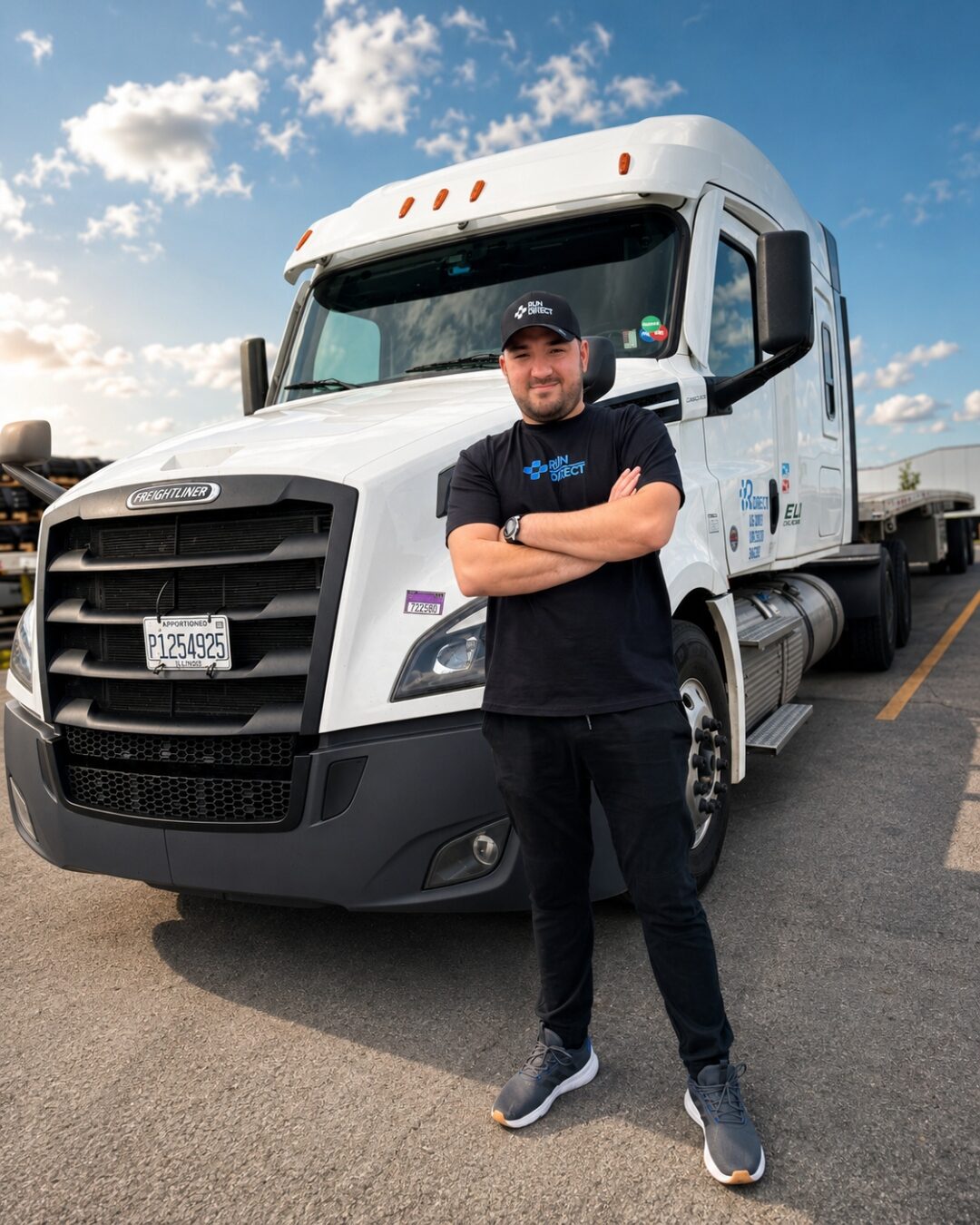 Run Direct flatbed driver standing in front of his 2024 Freightliner Cascadia