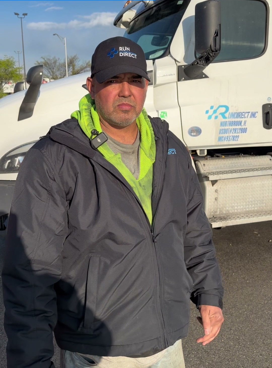 Michael Kendall, a real Run Direct flatbed driver of 3 years, standing in front of his Run Direct Cascadia
